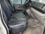 the interior of a white van with black seats and a steering wheel