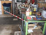 a garage with a lot of clutter and tools on the floor