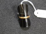 a ring that is sitting on top of a black object