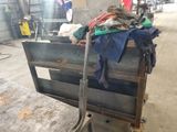a cart with clothes on top of it in a warehouse
