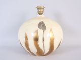 a white and gold vase with a flower on it