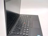 a black laptop with a red button on the keyboard