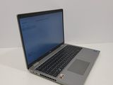 an open laptop computer sitting on top of a white table
