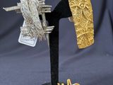 a close up of a metal object with a piece of gold on it