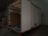 a large white truck that is parked in a garage