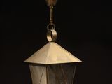 a close up of a light hanging from a ceiling in a dark room