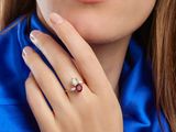 close up of a woman ' s hand with a ring on her finger