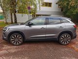 the grey suv is parked in front of a building