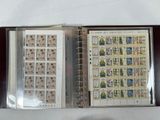 an open book with stamps on it sitting on a table