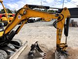 a yellow excavator that is sitting in the dirt