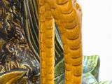 a statue of a man holding a bird in his hand