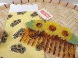 a yellow comb with yellow flowers on it sitting on a table
