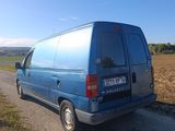 a blue van that is parked on the side of the road
