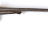 un vieux pistolet accroché au mur d'une pièce blanche