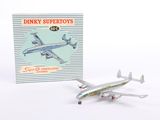 a toy airplane that is sitting next to a book