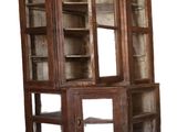 an old wooden cabinet with glass doors on it