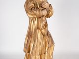 statue of a woman in a golden robe holding a book