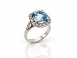 an oval blue topaze and diamond ring
