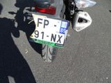 a motorcycle parked in a parking lot with a license plate on it