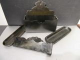 a metal box that has a knife, comb, and other items on it