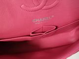 the inside of a pink chanel bag with a logo on it