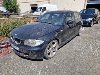 a black bmw car parked in front of a building