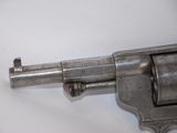 an old revolver on a white surface with a white background