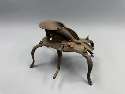 a small metal insect that is sitting on a table