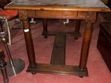 a wooden table with a metal top in a room