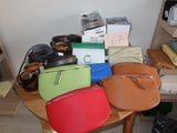 a table with a lot of purses and other items on it