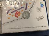 a small piece of paper with a coin on it