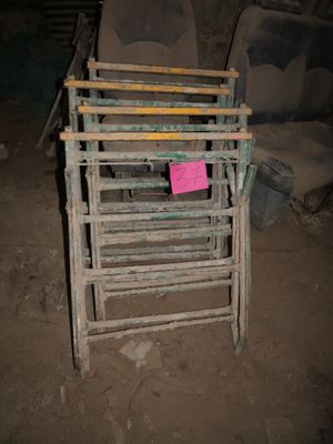 a pile of old chairs and a chair in a dirty room