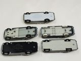 four pieces of silver and black cell phones sitting on top of a white table