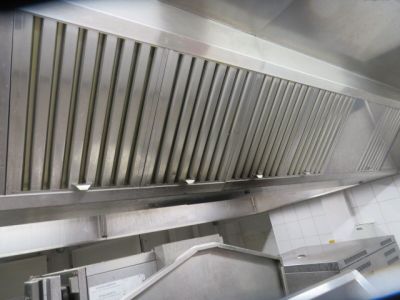 a view of a commercial kitchen from the top of the stairs