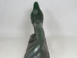 an image of a statue of a woman sitting on top of a marble block