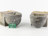 two cement pots sitting next to each other on a white surface