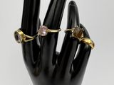 an image of a hand with two rings on it ' s fingers