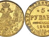 une pièce d'or sur laquelle figurent un oiseau et une couronne