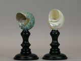 two vases sitting on top of each other on a table