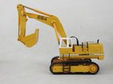 a yellow toy excavator that is on a white surface