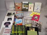 a table with many books and a lamp on it