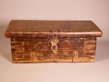 an old wooden box with a lock on top of it