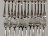 a close up of a bunch of silverware on a table