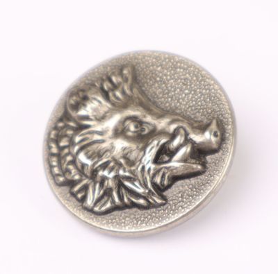 a close up of a metal button with a lion head on it