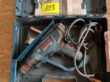 a tool box with a corded drill and other tools in it