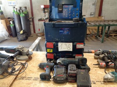 a pile of tools sitting on a table in a workshop