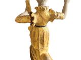 statue of a woman holding a bird on a white background