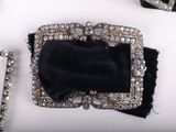 several pieces of jewelry are displayed on a white surface