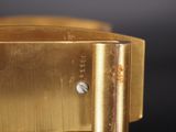 an image of a close up of a gold watch on a black surface