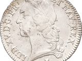 a silver coin with a woman ' s head and a crown on it